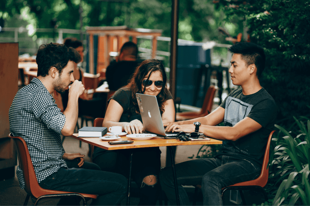 People sat around a table together with a laptop