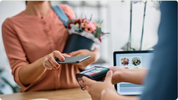 A card reader with a phone tapping it to pay