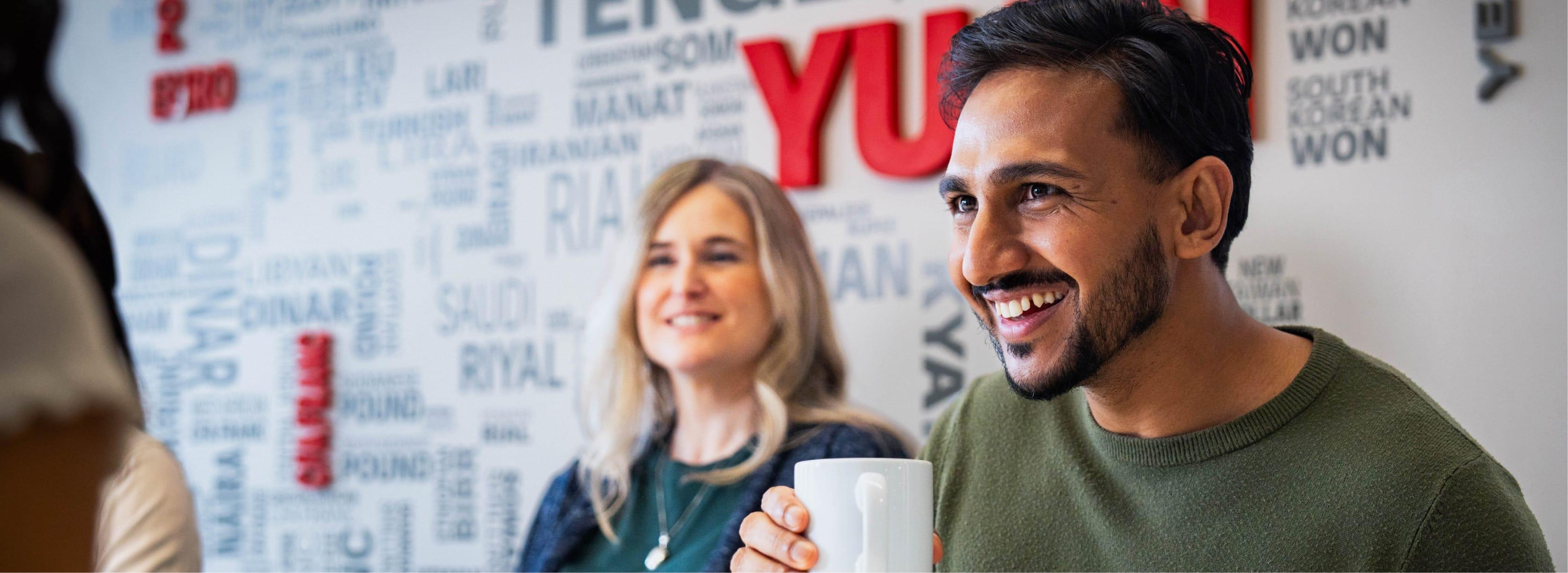 Two employees are smiling together