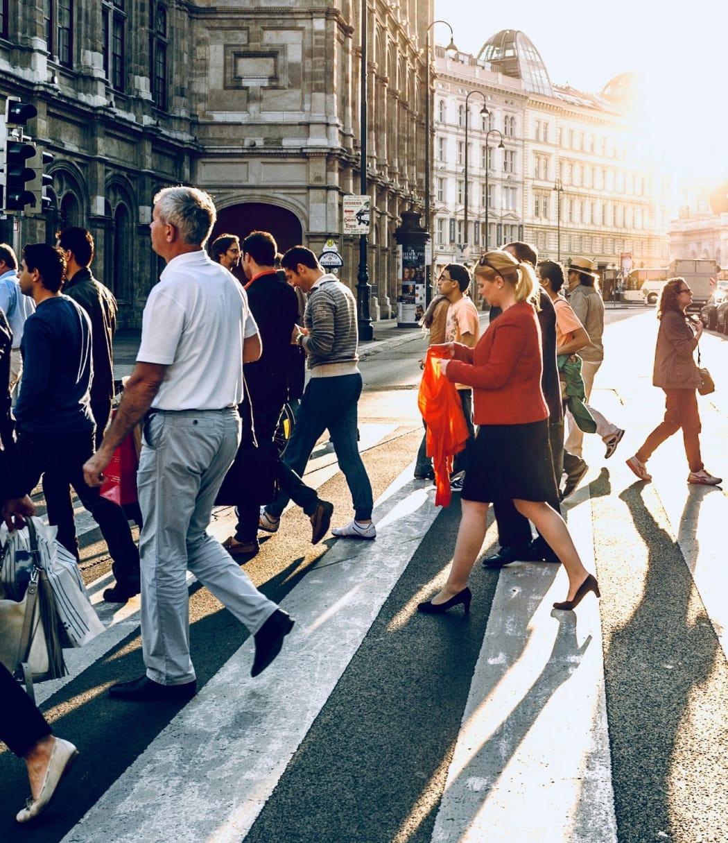 People walking in between city buildings