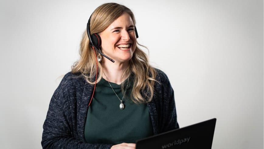 Person with a headset smiling.