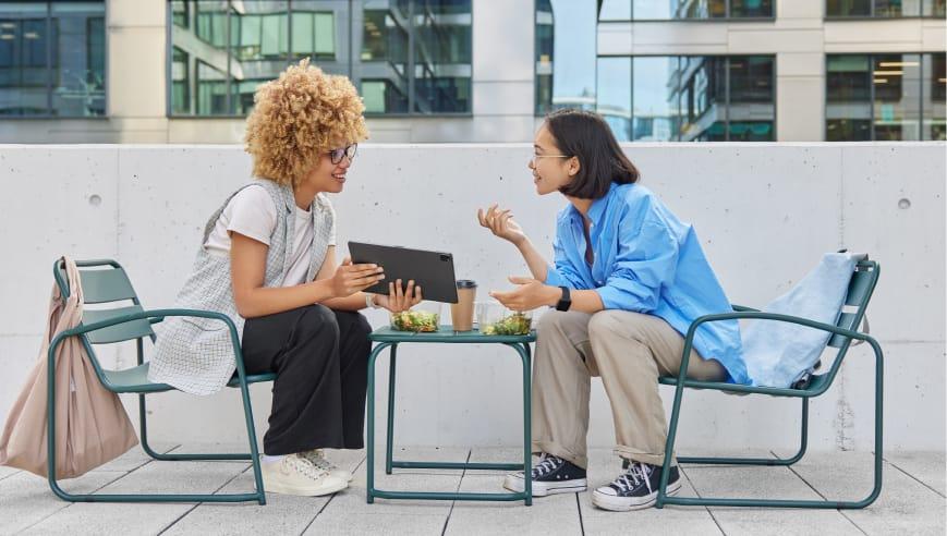 young women talking outside