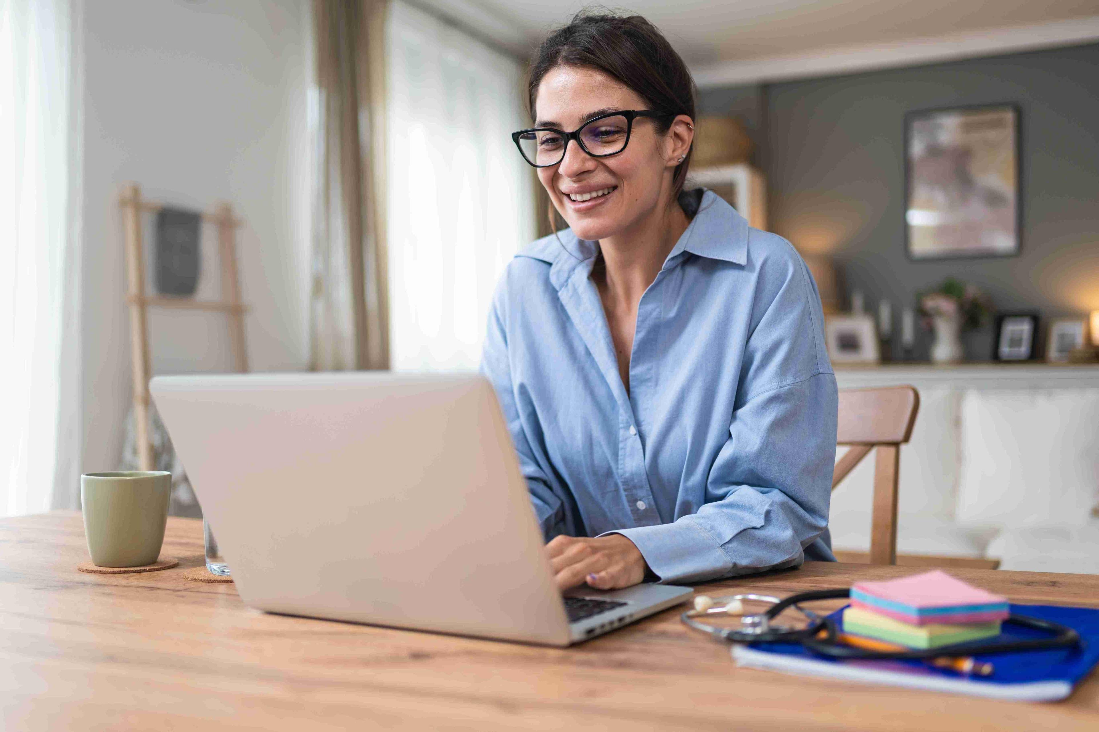 Woman smiling at computer applying for a new job