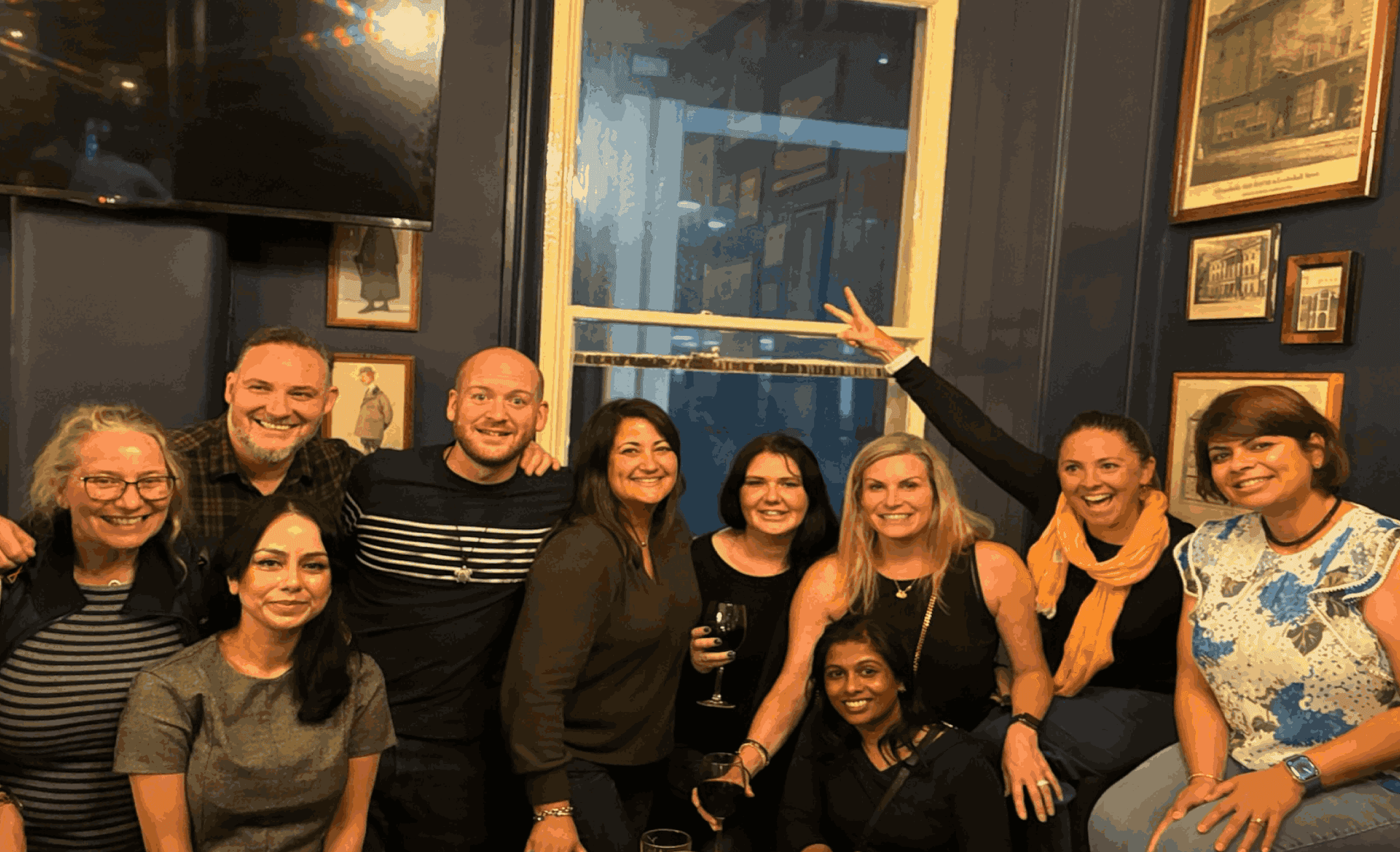 A group of people smiling and laughing in a room