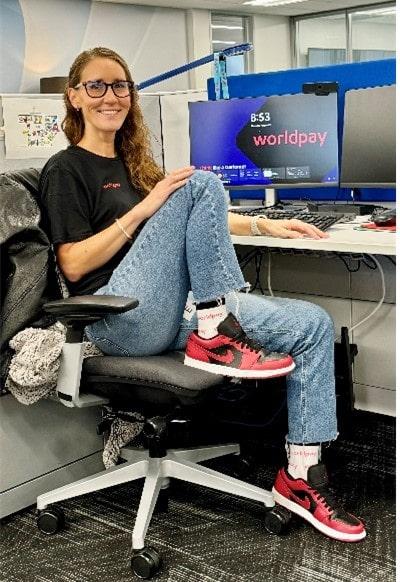 Working at desk in red sneakers