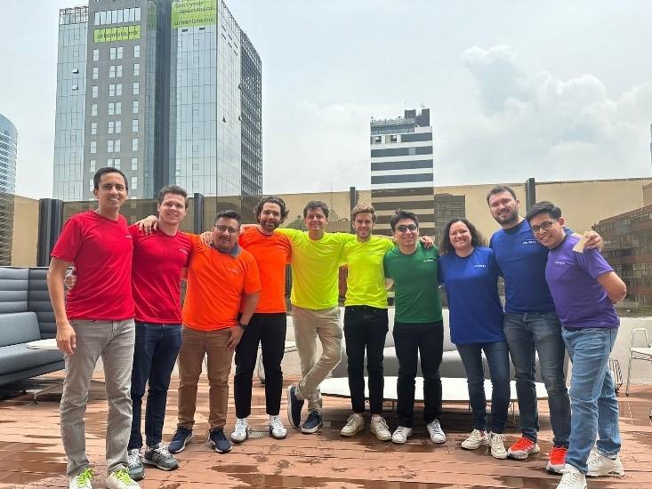 LATAM colleagues wearing bright colored shirts