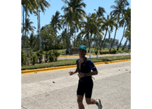 Man running with palm trees behind