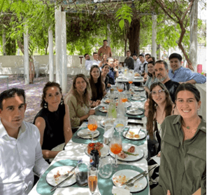 Group of colleagues eating meal around table