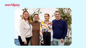colleagues in an office with plants behind them