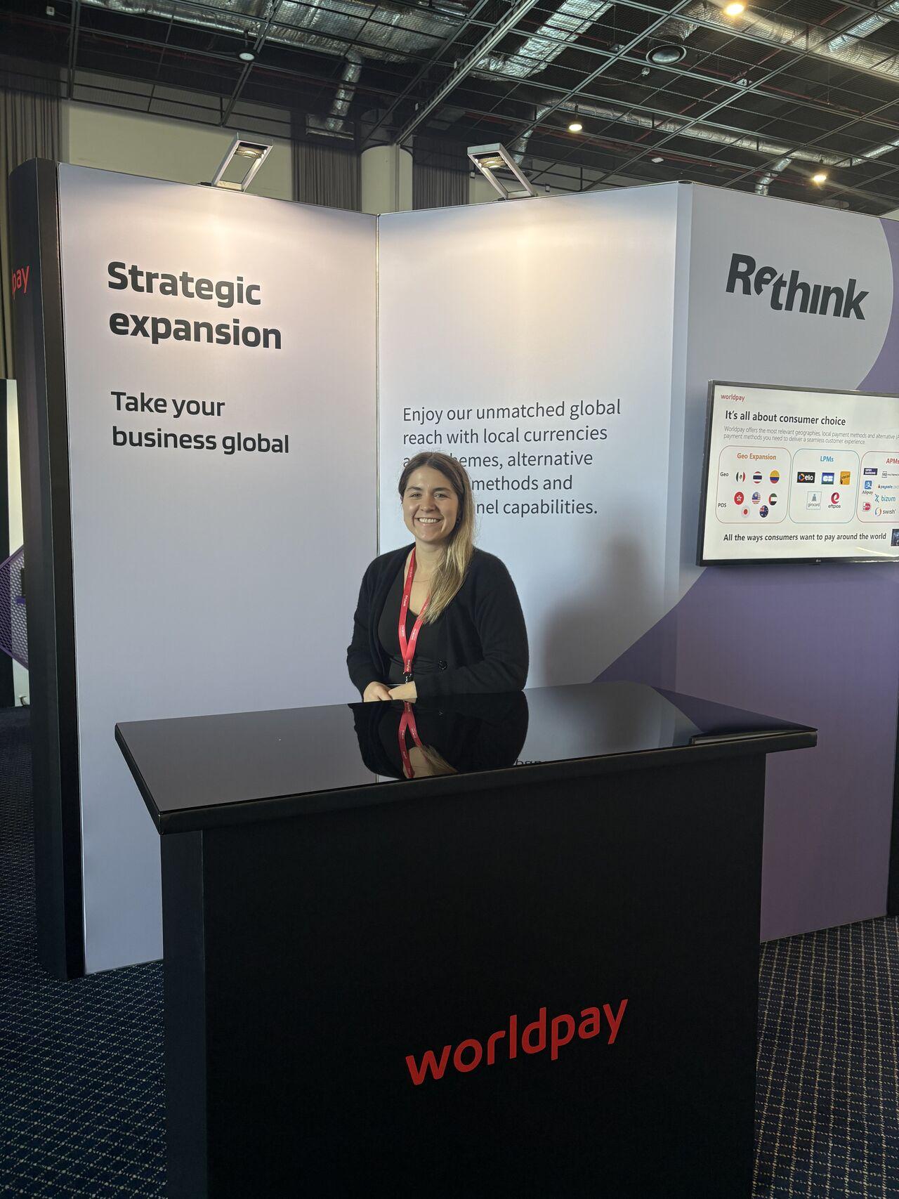 female standing at booth