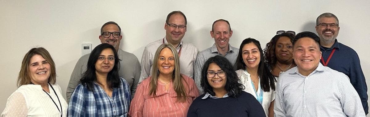 Group of people smiling looking at camera