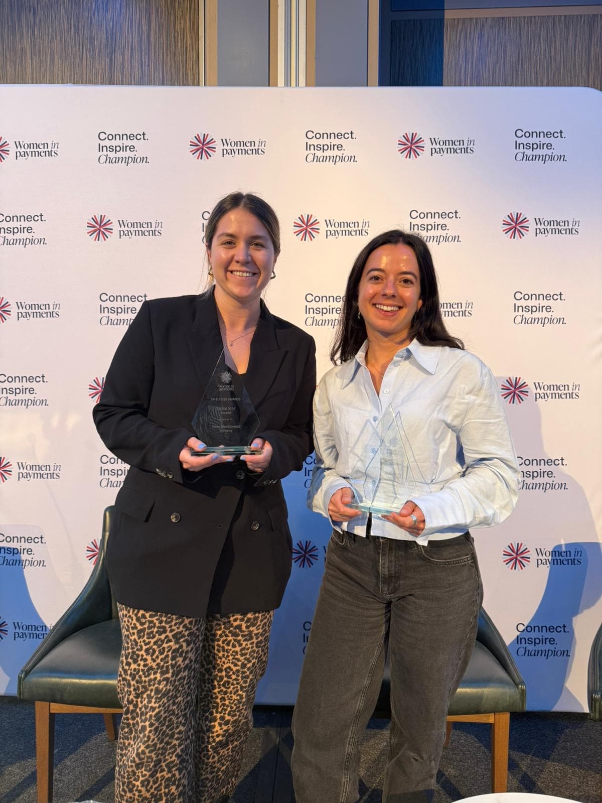 two women holding their awards