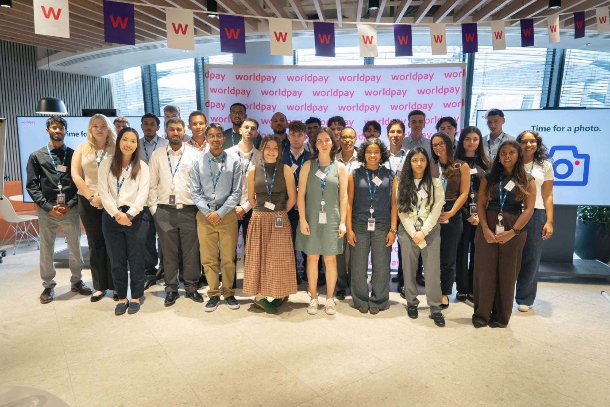 Worldpay people gathered in front of a Worldpay sign